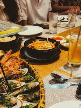 Lively dining scene featuring various seafood dishes, a perfect gathering with friends.