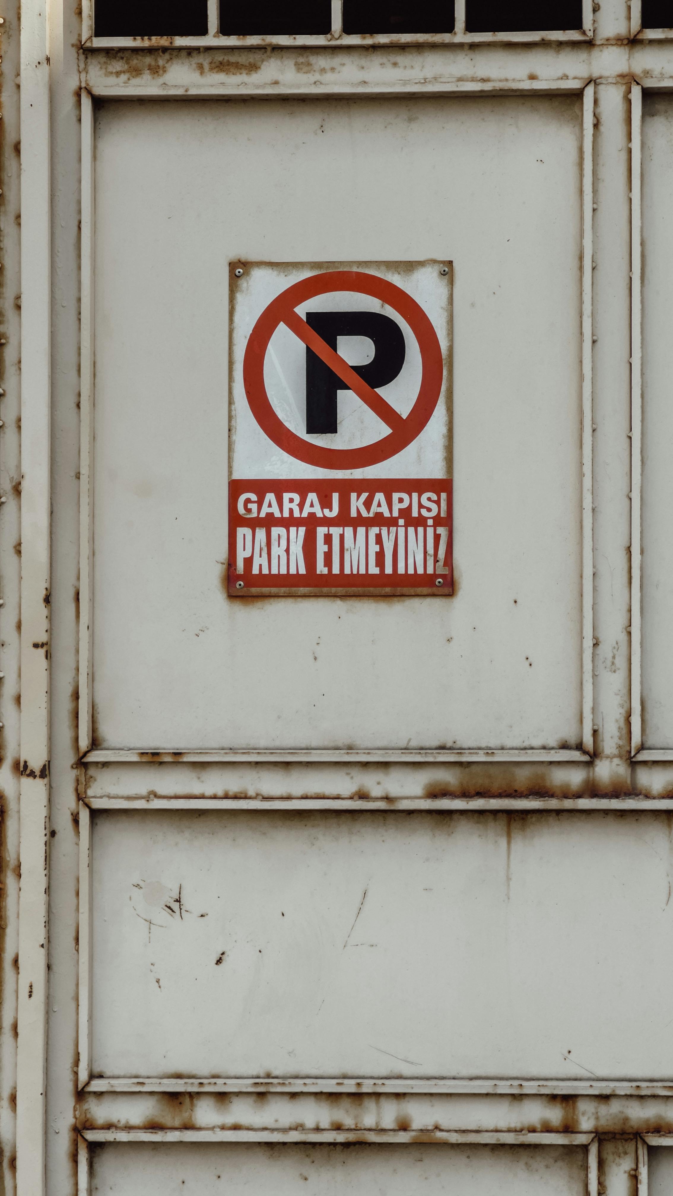 a no parking sign on a white door