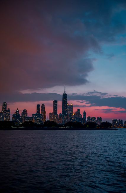 Capture the beauty of Chicago's skyline at dusk, with vibrant skies and illuminated buildings.