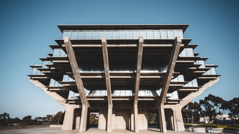a cantilevered concrete library at midday — photograph by Rick Han on Pexels