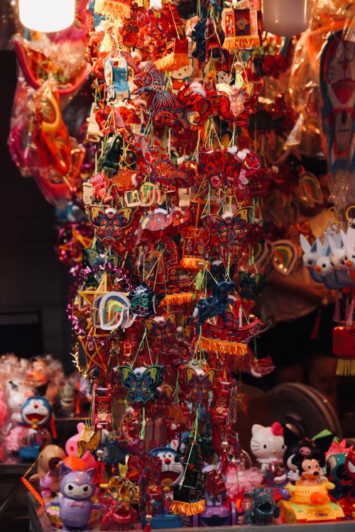 Free Colorful handmade festival decorations and toys on display at a traditional market stall, ideal for cultural celebration themes. Stock Photo