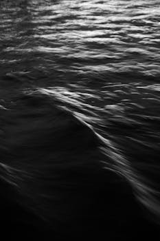 A mesmerizing black and white abstract image of ocean waves with a smooth texture, perfect for backgrounds.