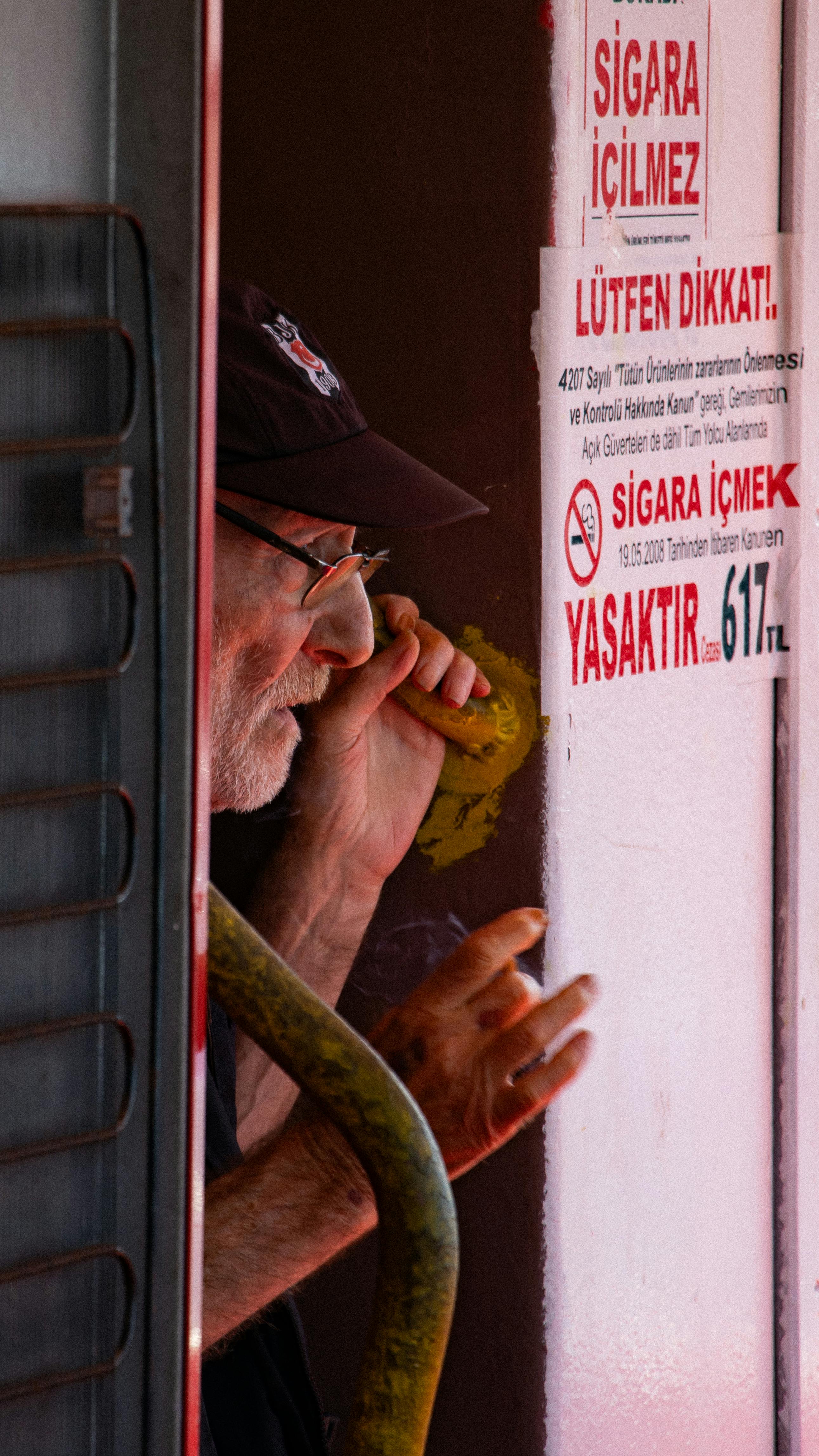 a man is talking on a cell phone while standing in a doorway