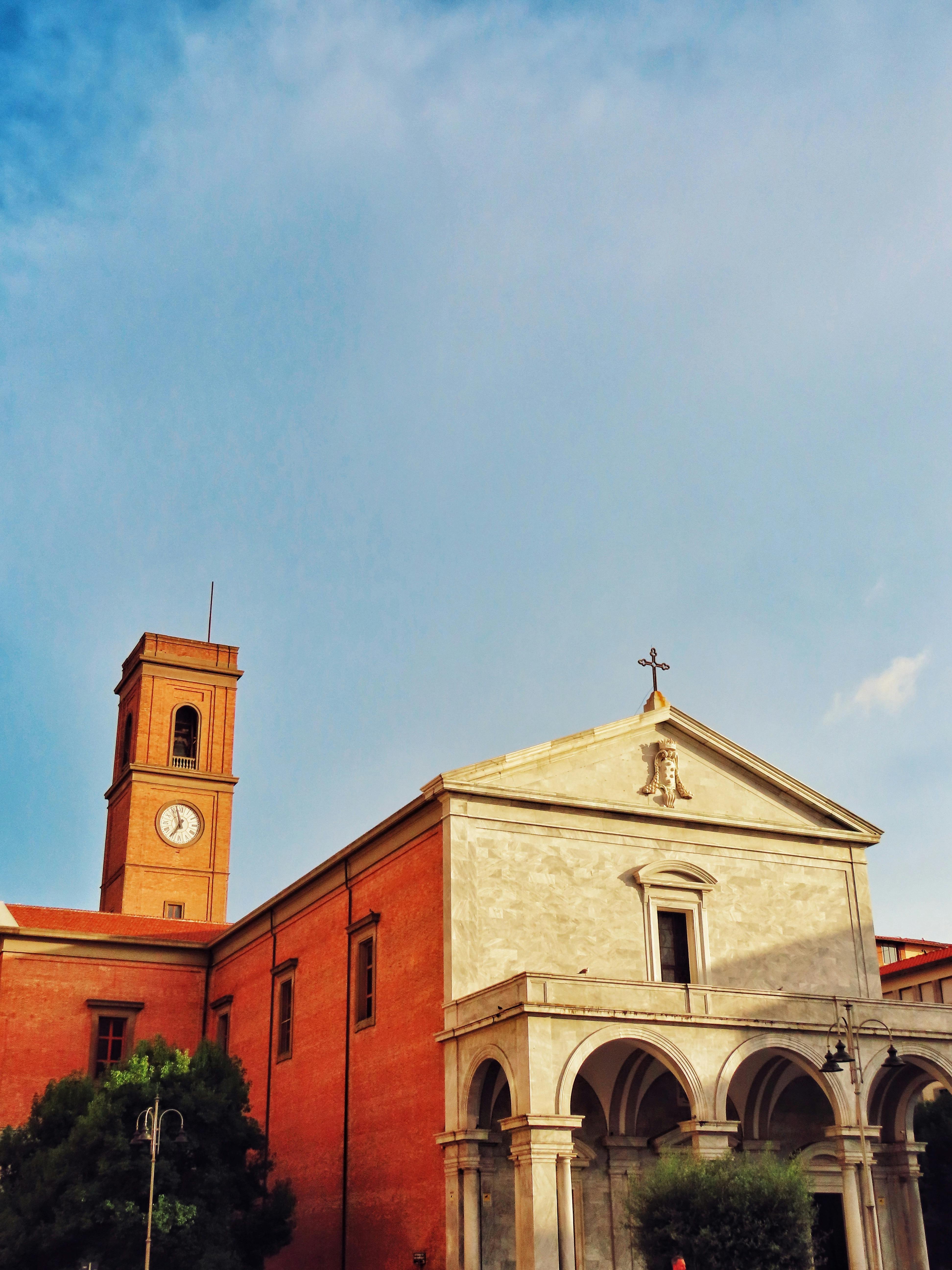 a church with a clock tower in the background