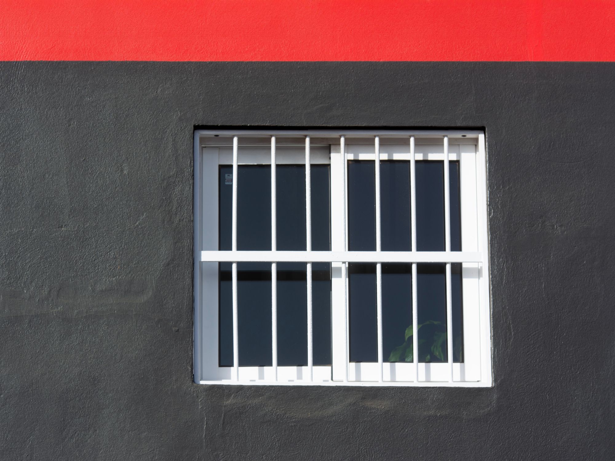 Exterior Painting in North Woolwich, Newham — painter refreshing a house exterior in weatherproof paint