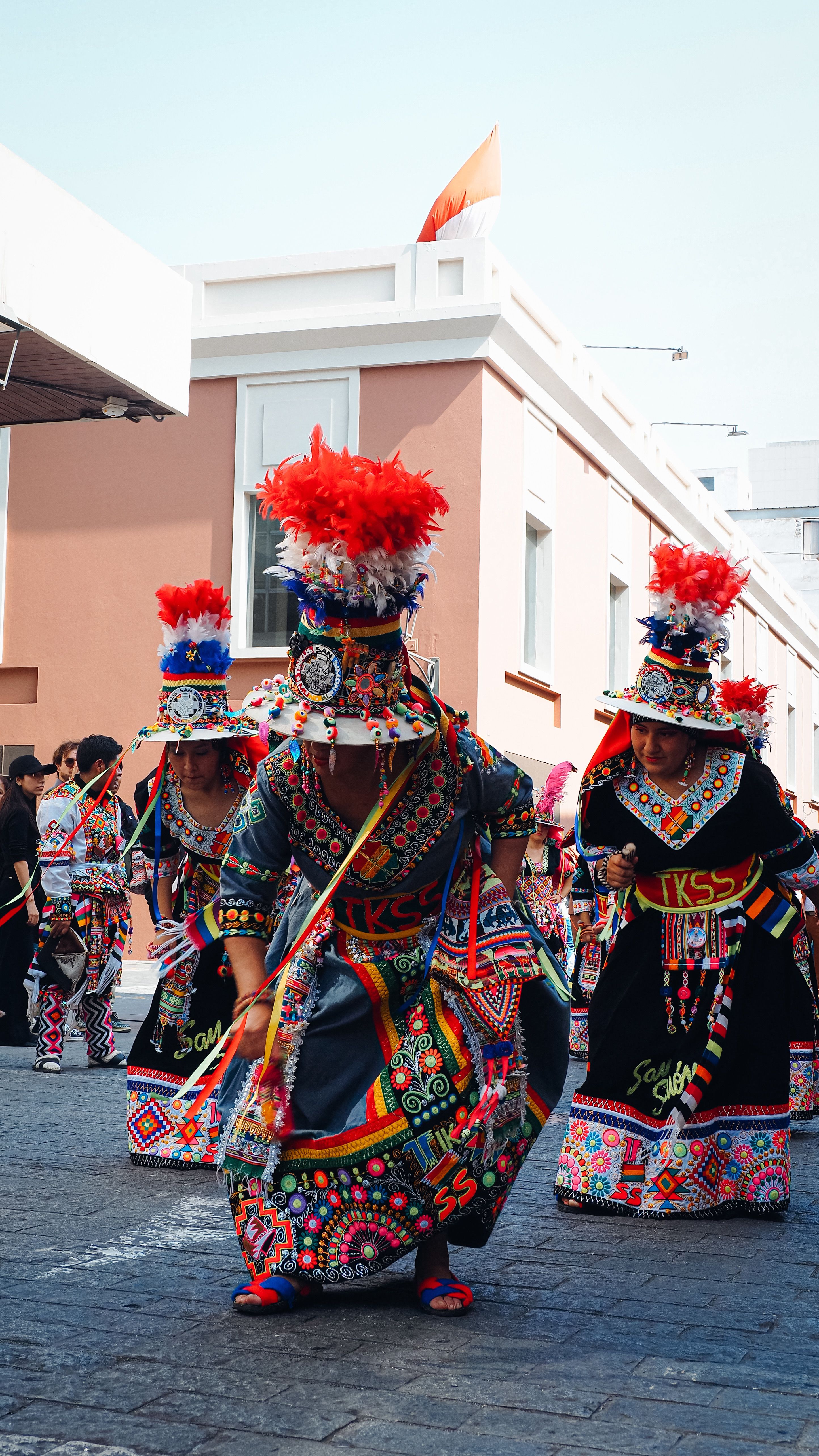 Vibrant cultural street performance in Lima with dancers in traditional Peruvian costumes.