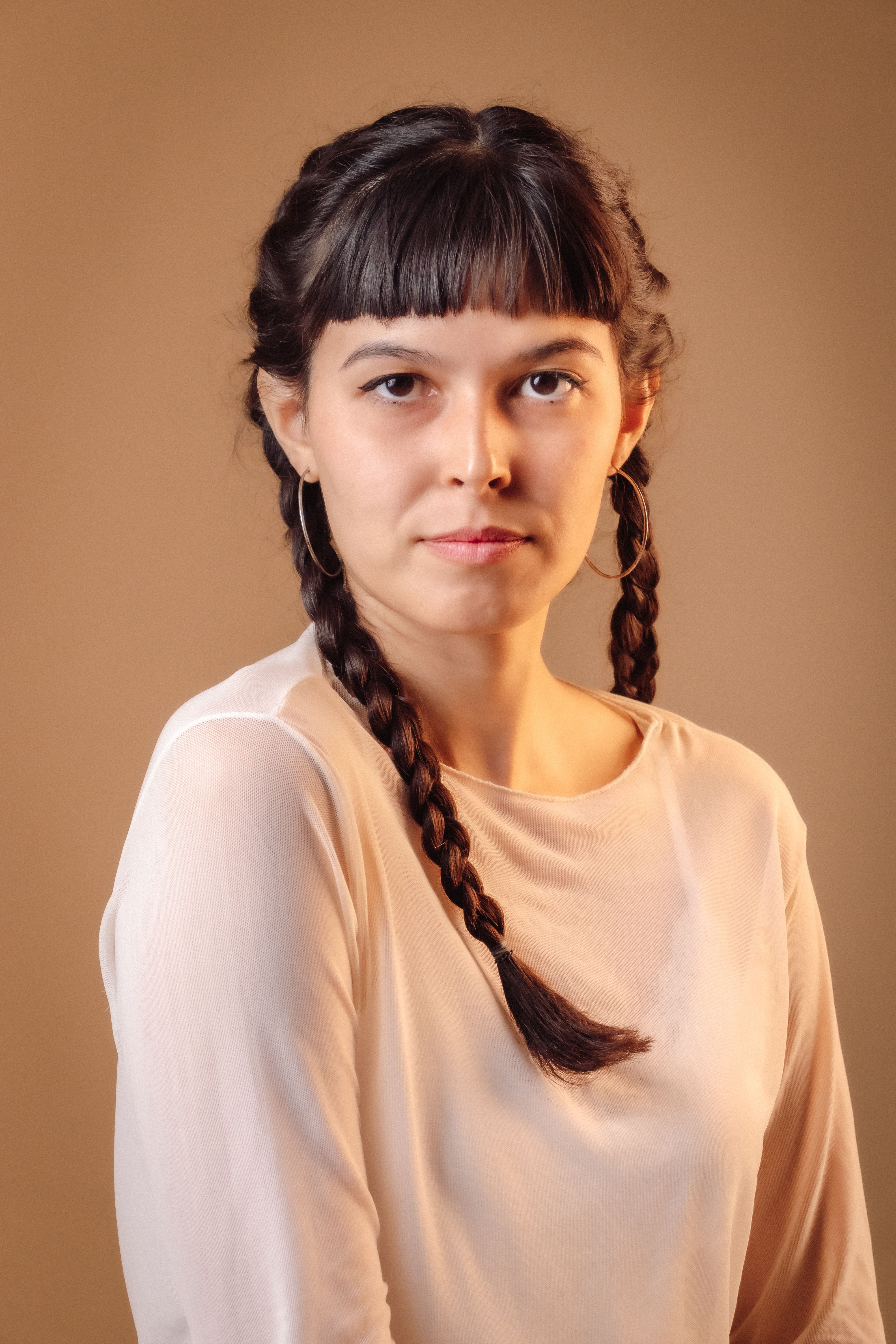 A woman with long hair and a braid on her head · Free Stock Photo