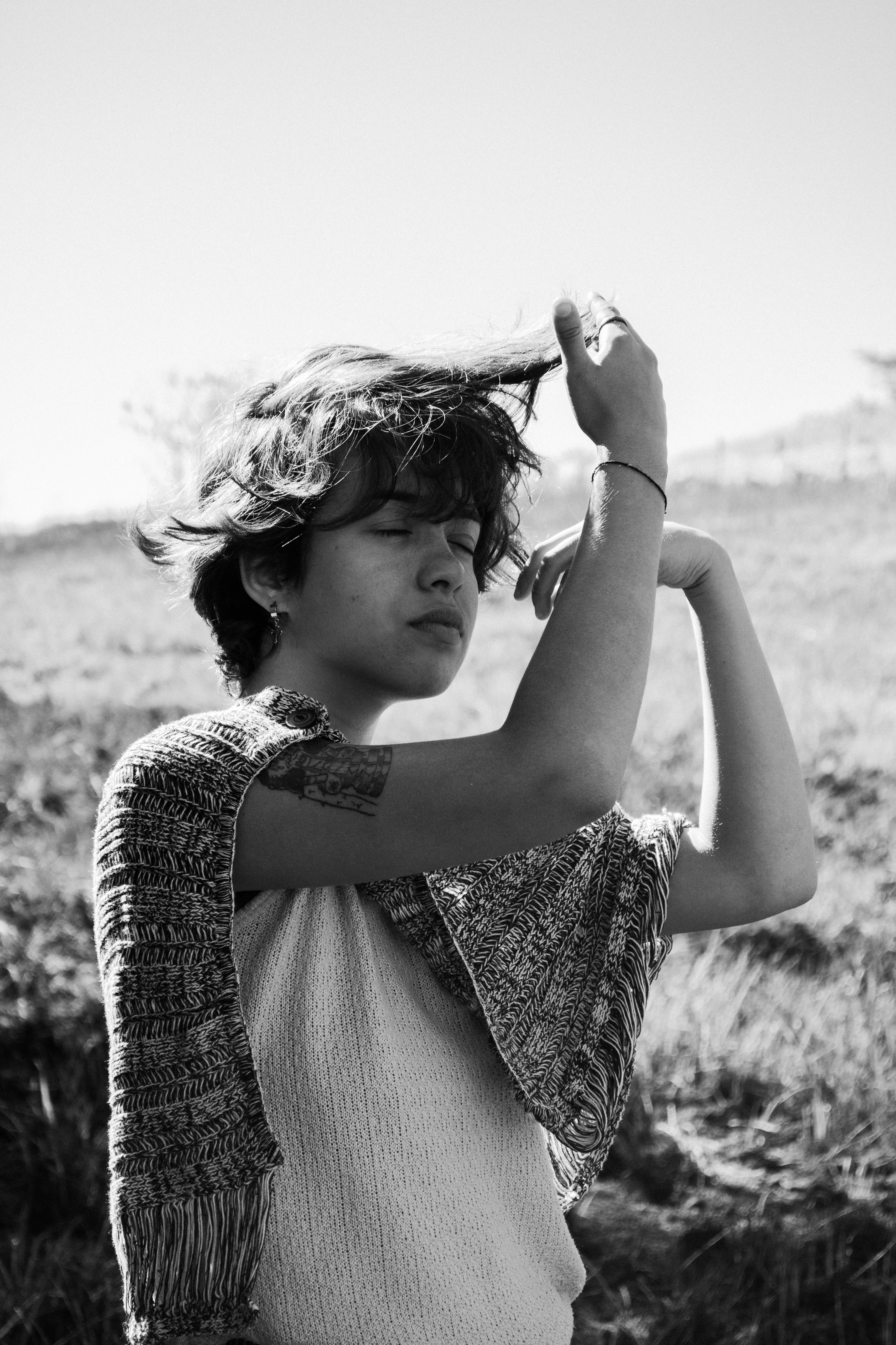 Black and white portrait of a woman with closed eyes in an outdoor setting, Rio de Janeiro.