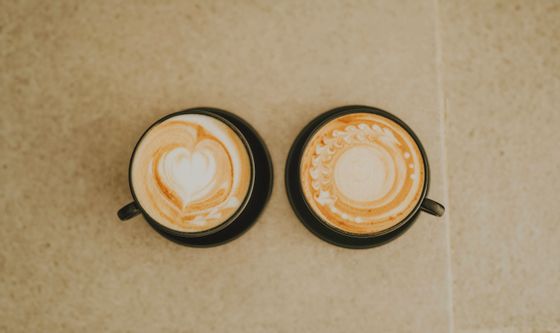 Two cappuccinos with latte art