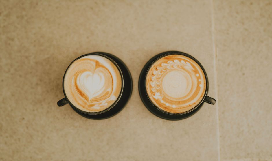 Two cappuccinos with latte art