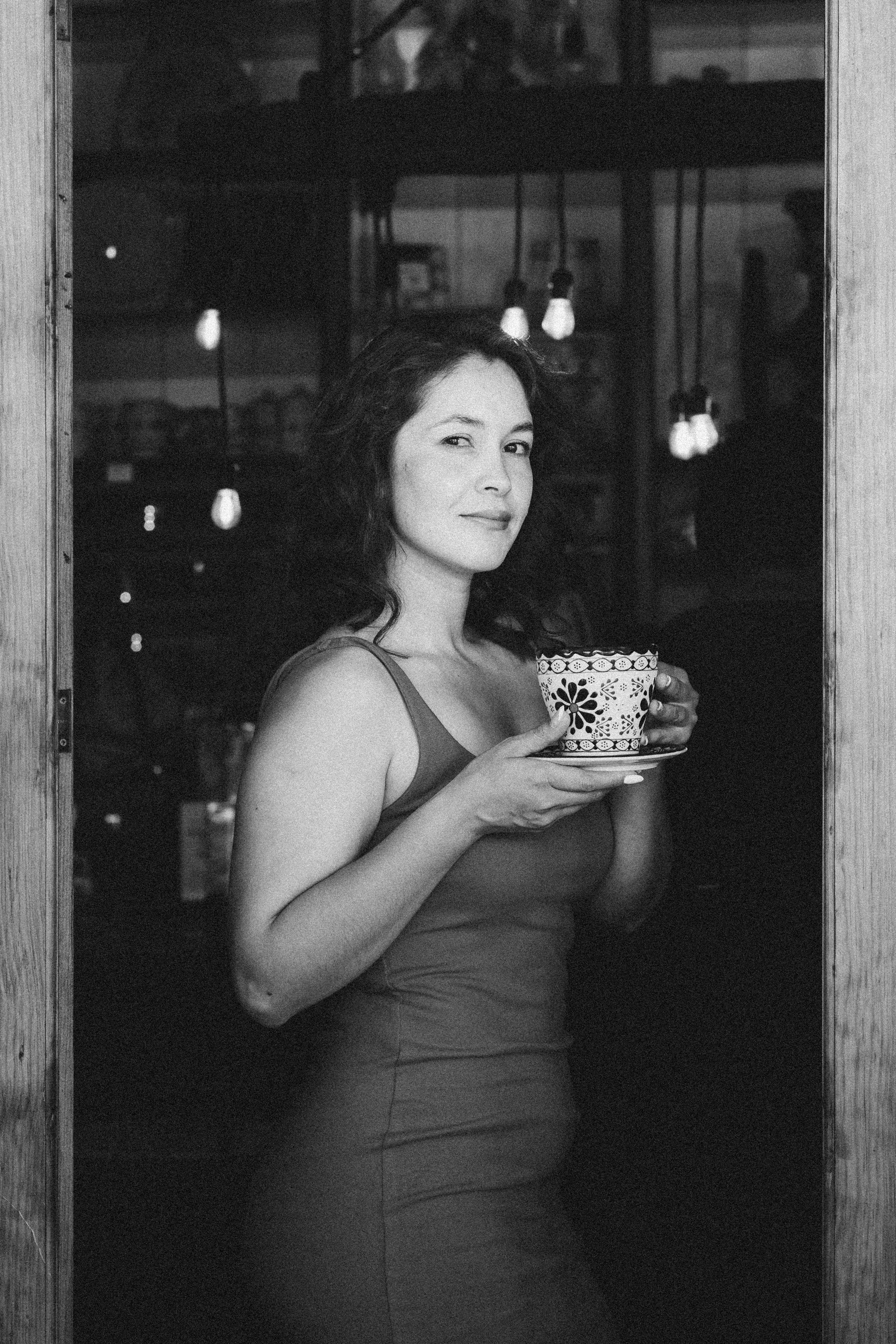 Woman with a Porcelain Cup Standing in the Doorway of a Cafe · Free ...