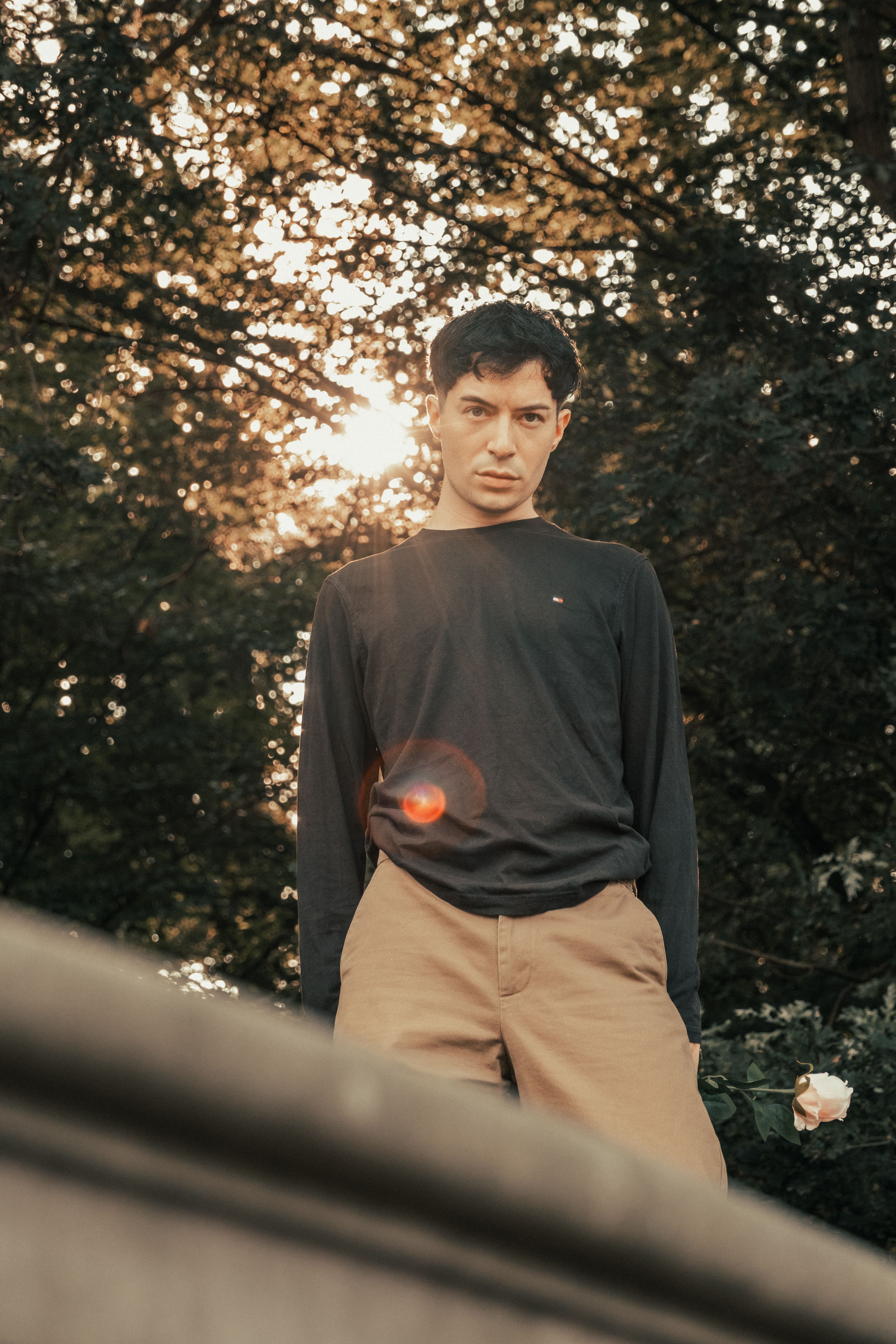 A man standing in the sun wearing a black shirt · Free Stock Photo