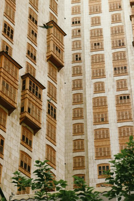 Detailed view of a building's facade showcasing traditional wooden windows and intricate design.