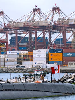 Busy shipping port in Callao, Peru with containers, cranes, and a Peruvian flag.