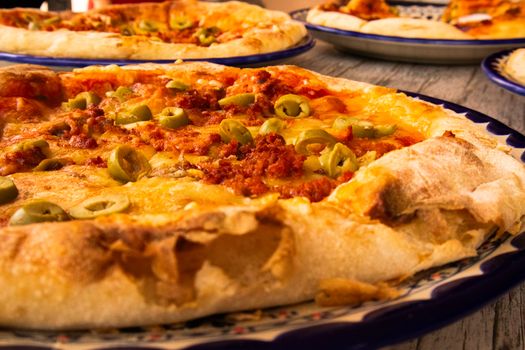 Tasty pizza topped with green olives and melted cheese, perfect for dinner or lunch.