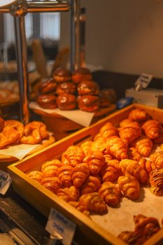 Golden croissants displayed in a bakery in Dubai, showcasing the art of pastry making.