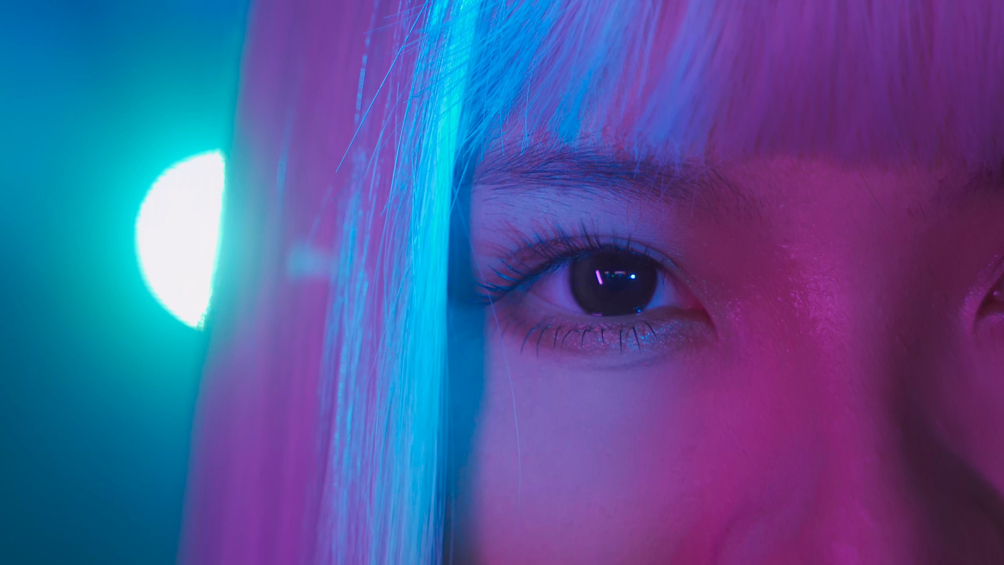 A woman with pink hair and blue lights · Free Stock Photo