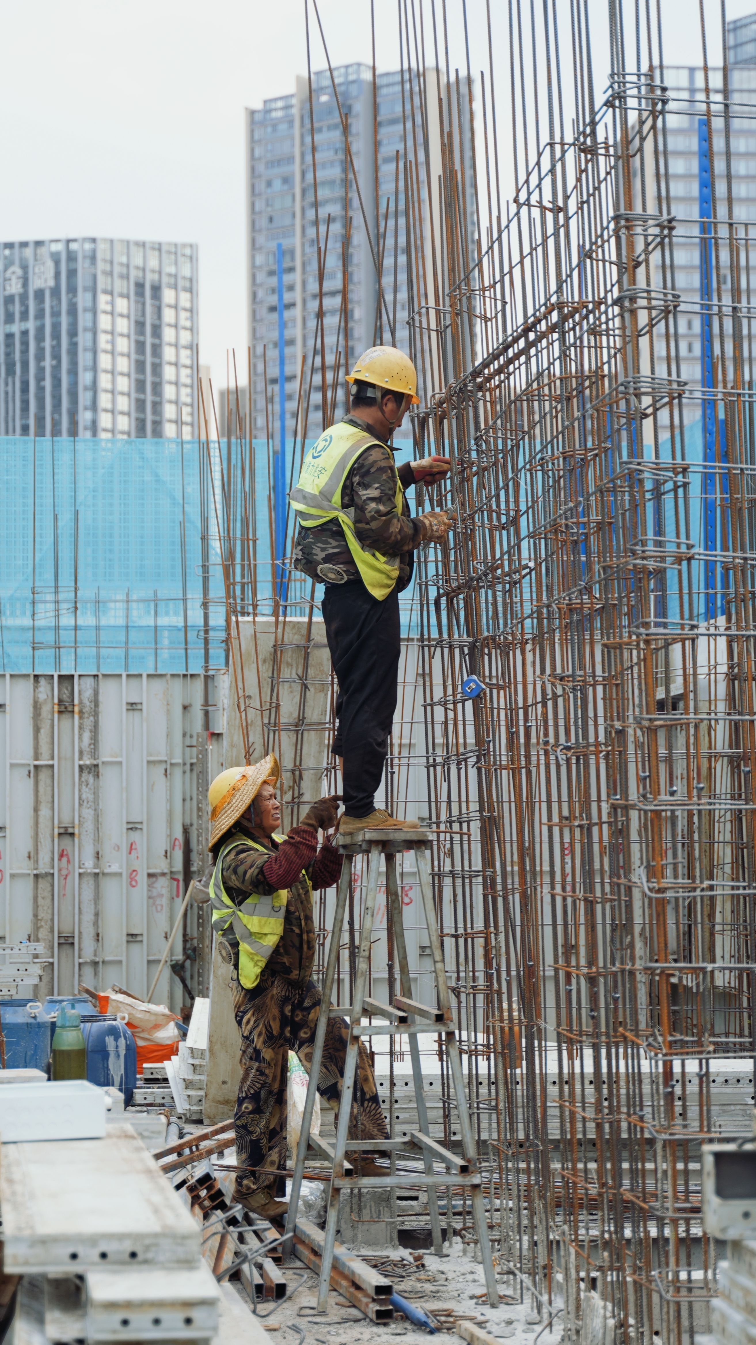 Construction specialists assembling structural steel on a city site