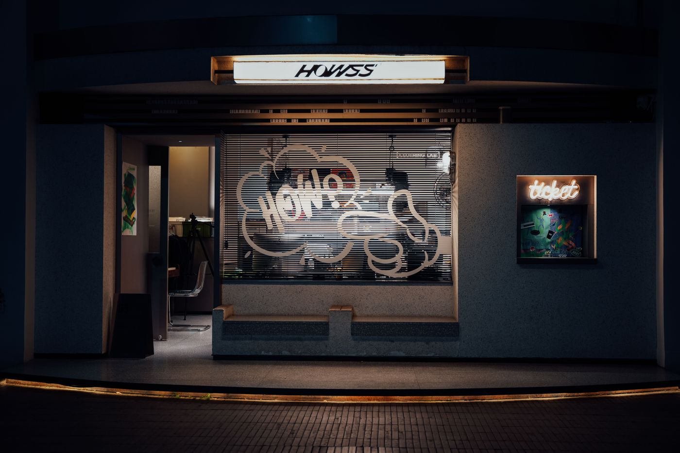 Modern illuminated storefront at night with neon signage
