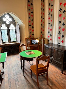 A room with a table and chairs and a wall with a chess board by Stephan Leuzinger