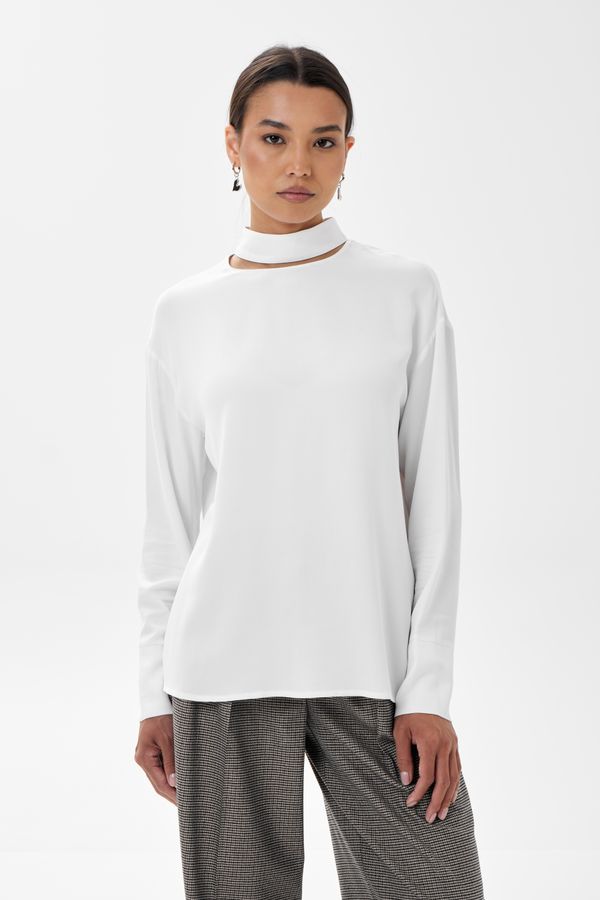 Woman in a mock-neck top with wide-leg pants