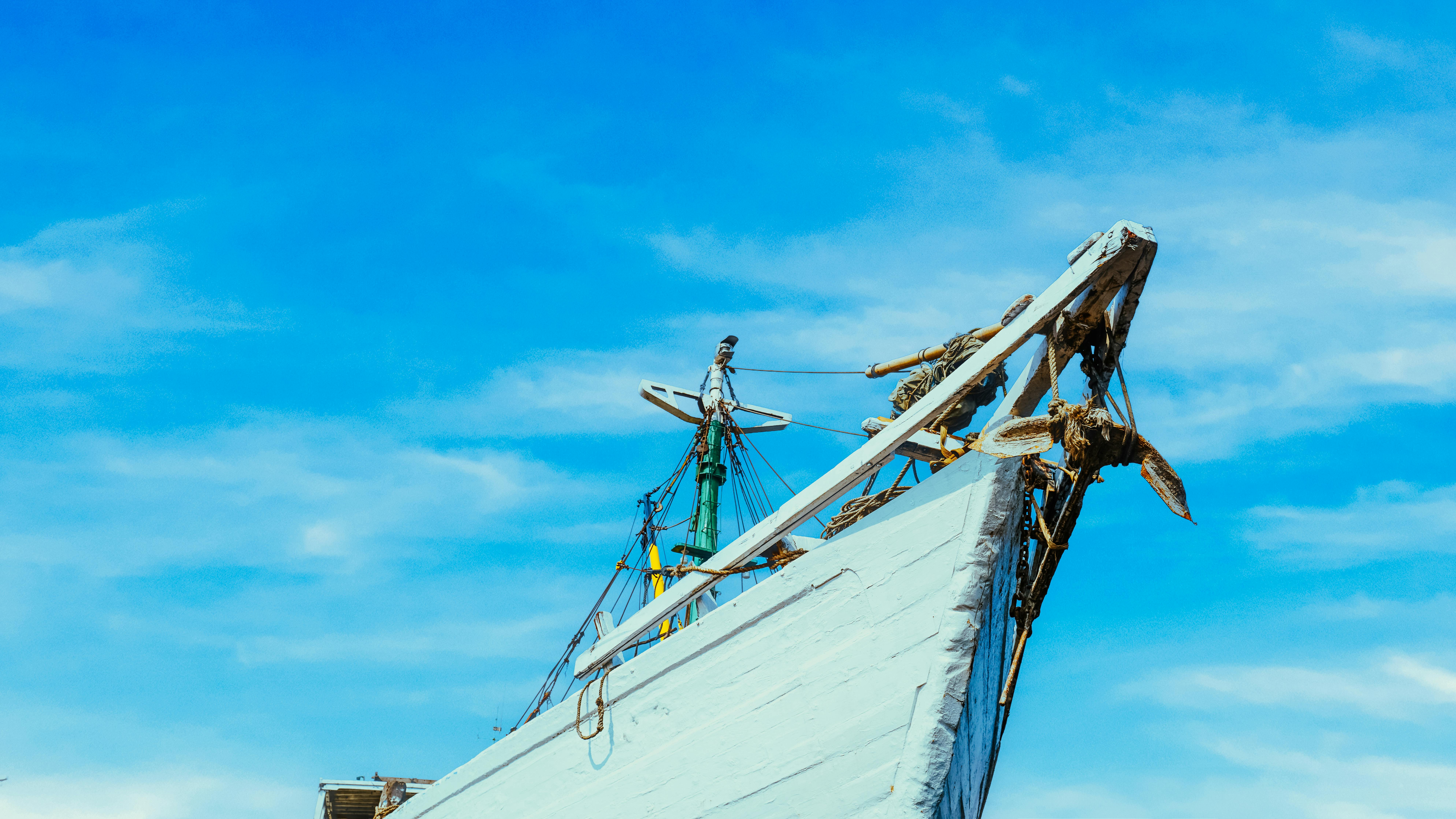 A beautiful traditional wooden ship against a vibrant blue sky, showcasing maritime heritage.