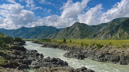 Free Beautiful Altai landscape with river flowing through rugged mountains under a dramatic sky. Stock Photo