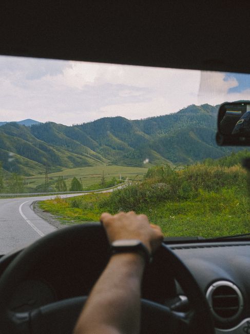 Experience a breathtaking drive through Altai's lush mountains. Perfect for travel enthusiasts.