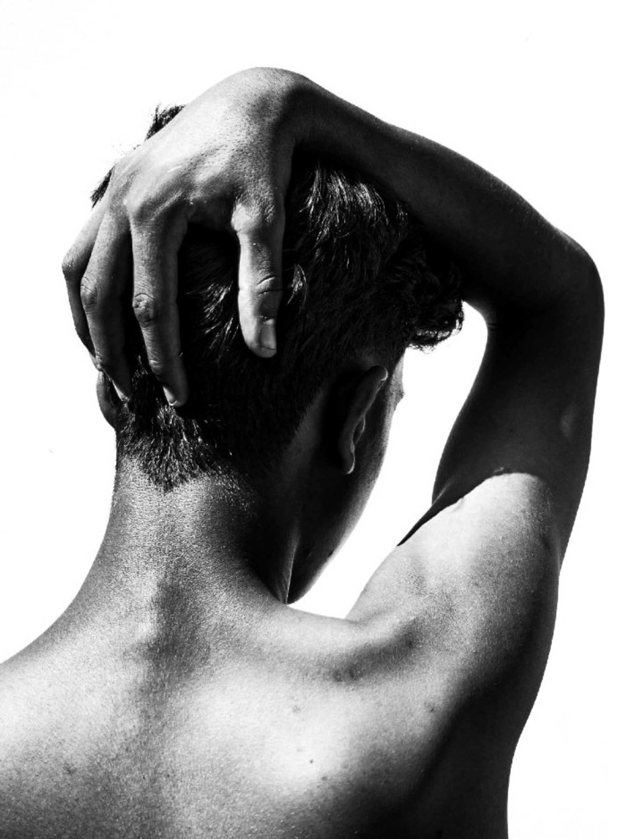 A black and white photo of a man with his hands on his head · Free ...