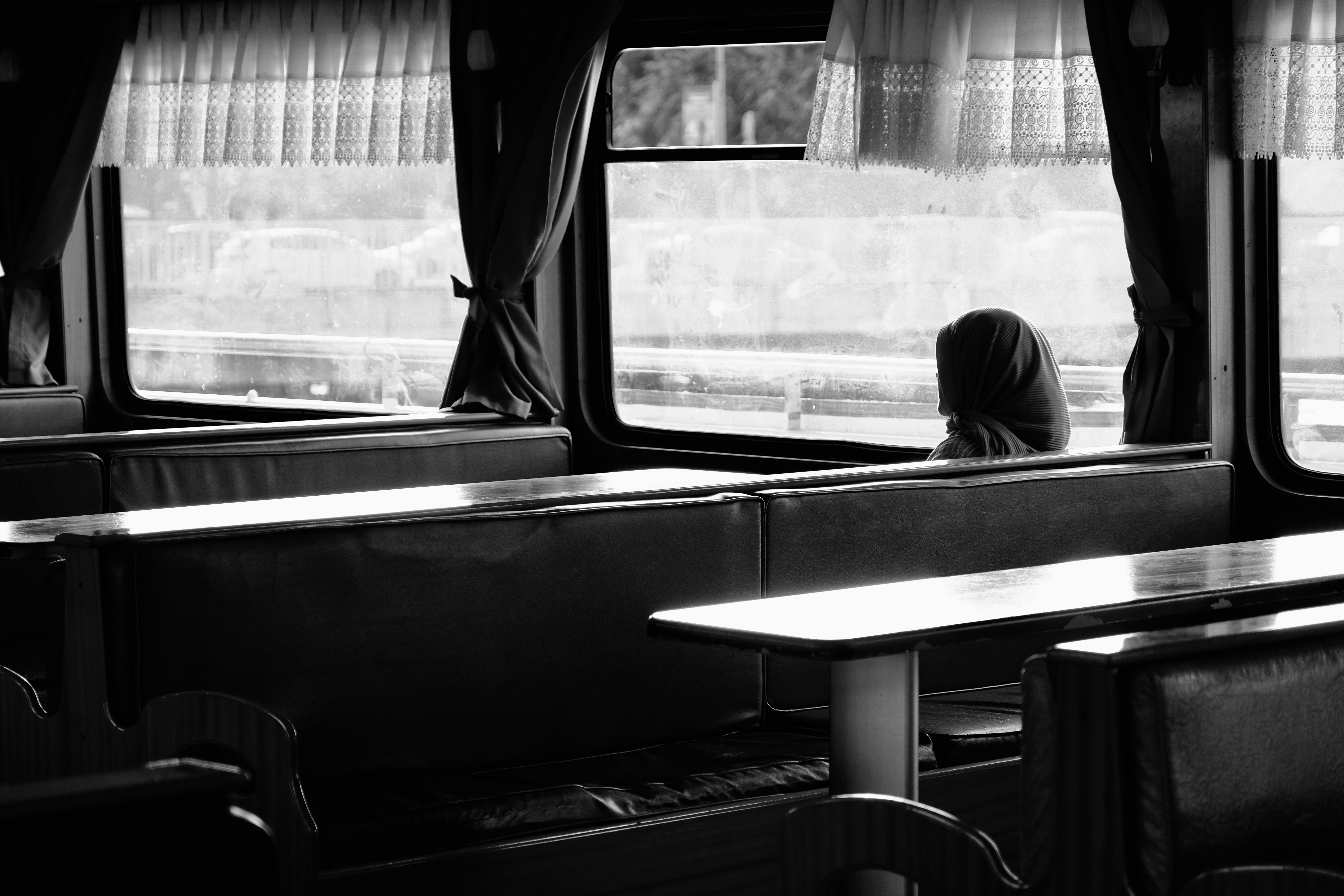 person looking out of a train window at a beautiful Japanese landscape, pensive