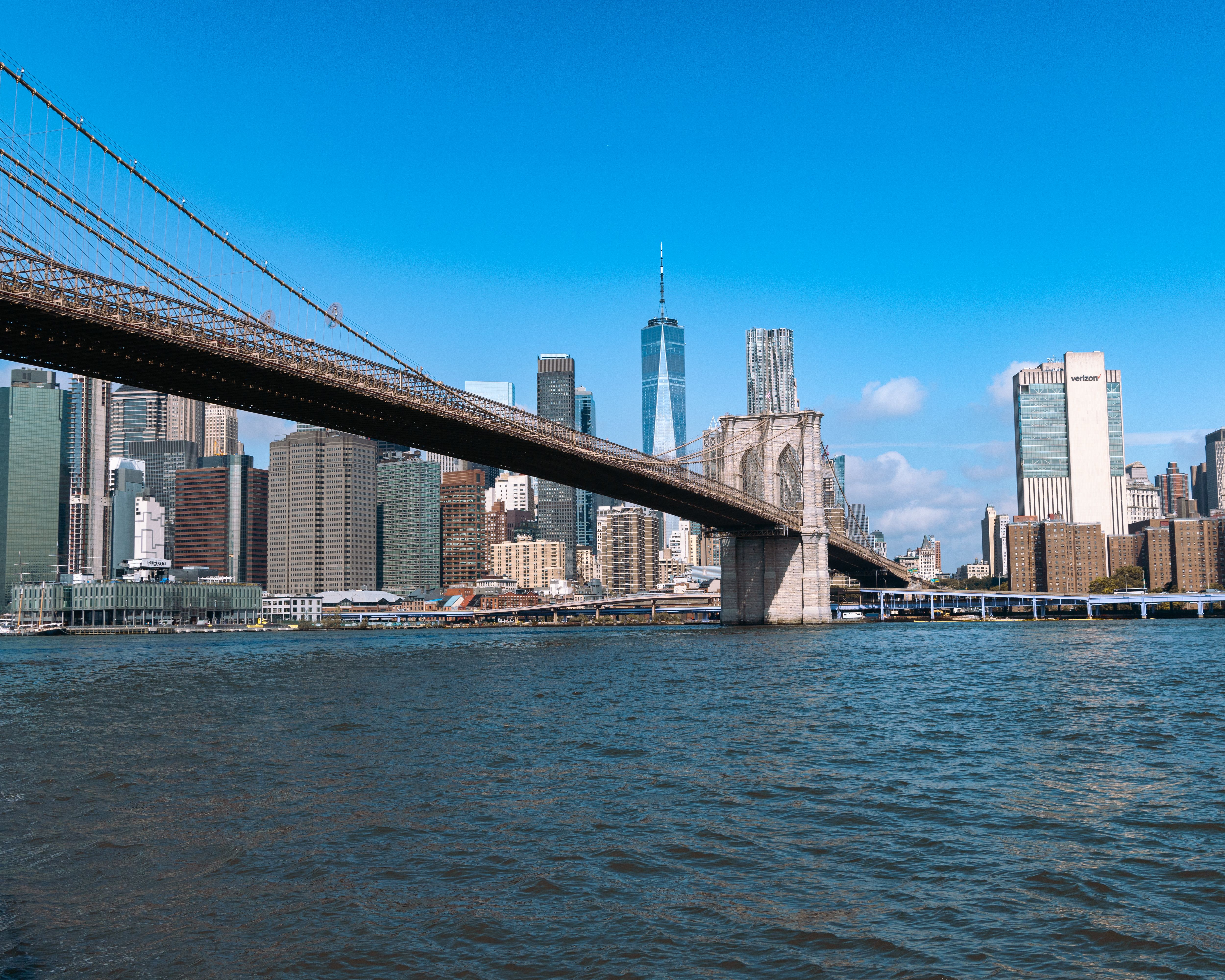 Scenic shot of the Brooklyn Bridge with New York City's skyline in the background on a clear day.