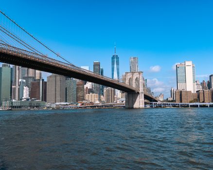 Scenic shot of the Brooklyn Bridge with New York City's skyline in the background on a clear day.