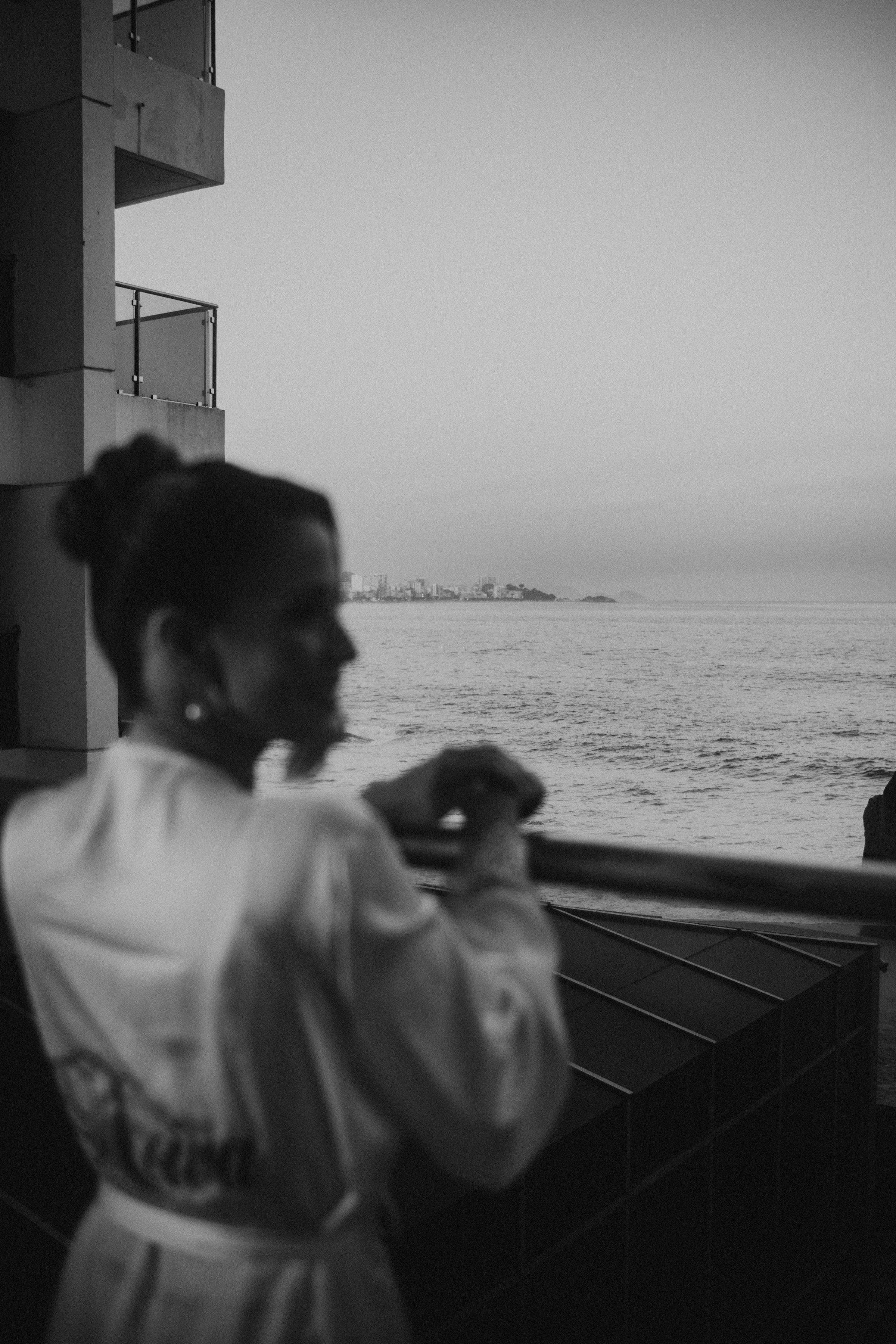 A woman in a robe looking out at the ocean · Free Stock Photo