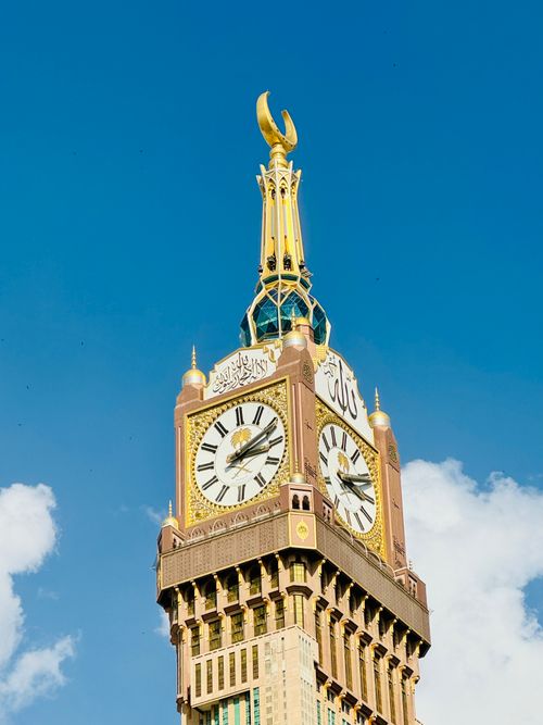 Free The iconic Abraj Al Bait clock tower in Makkah, Saudi Arabia, stands tall under a vibrant blue sky. Stock Photo