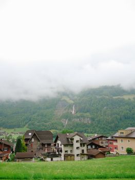 Tranquil Swiss village surrounded by lush mountains and a serene summer atmosphere.