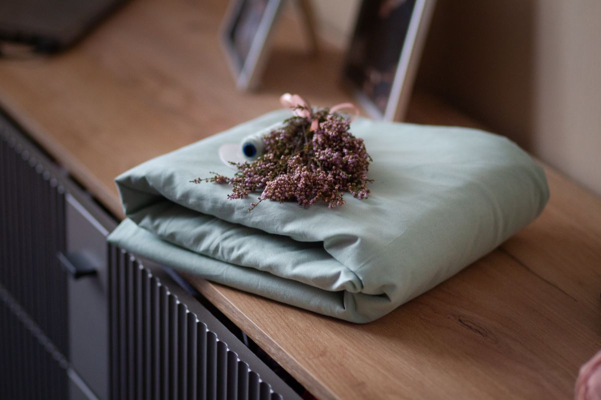 Warm lighting in sage green bedroom