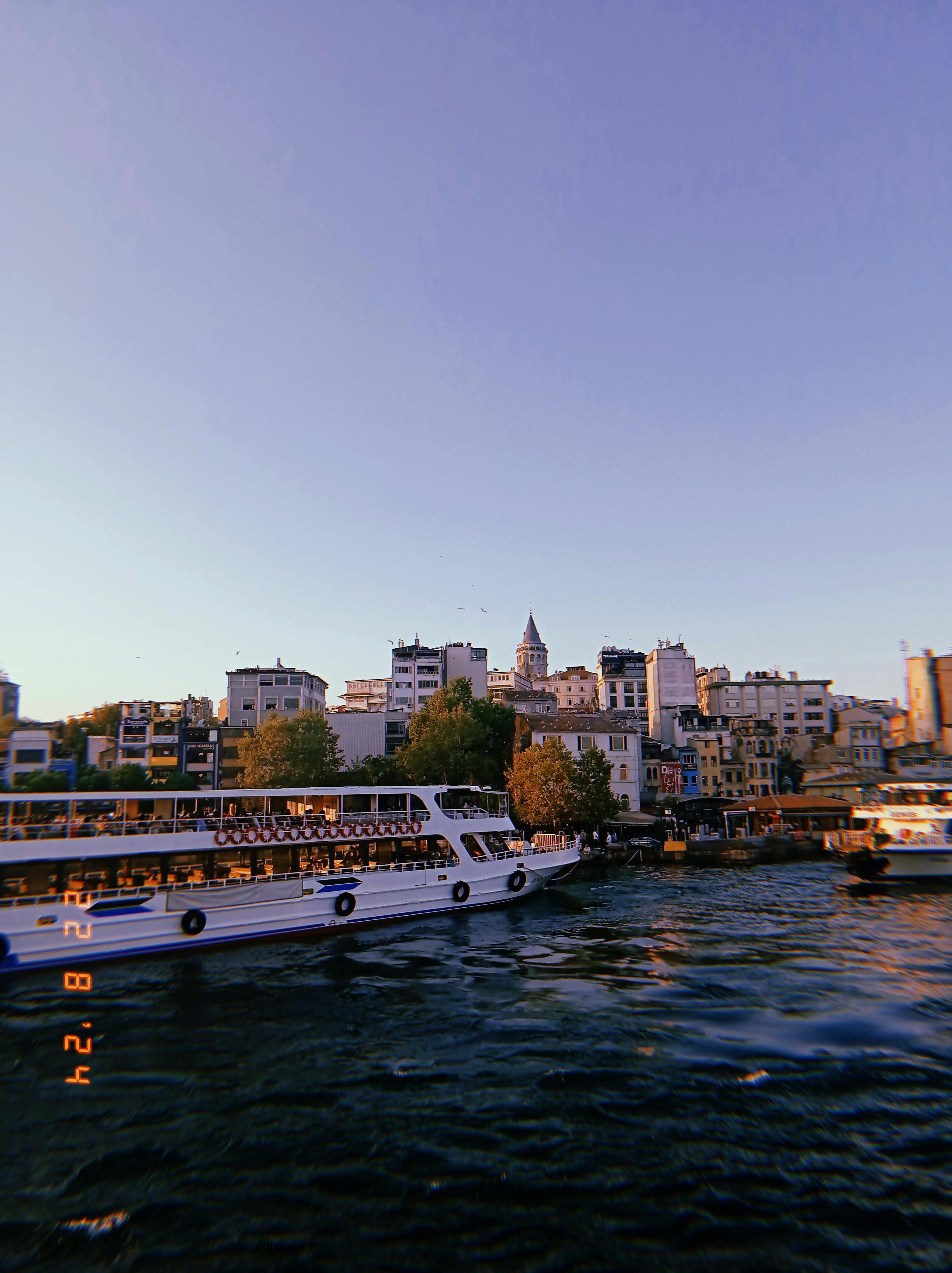 a boat is traveling down a river near a city