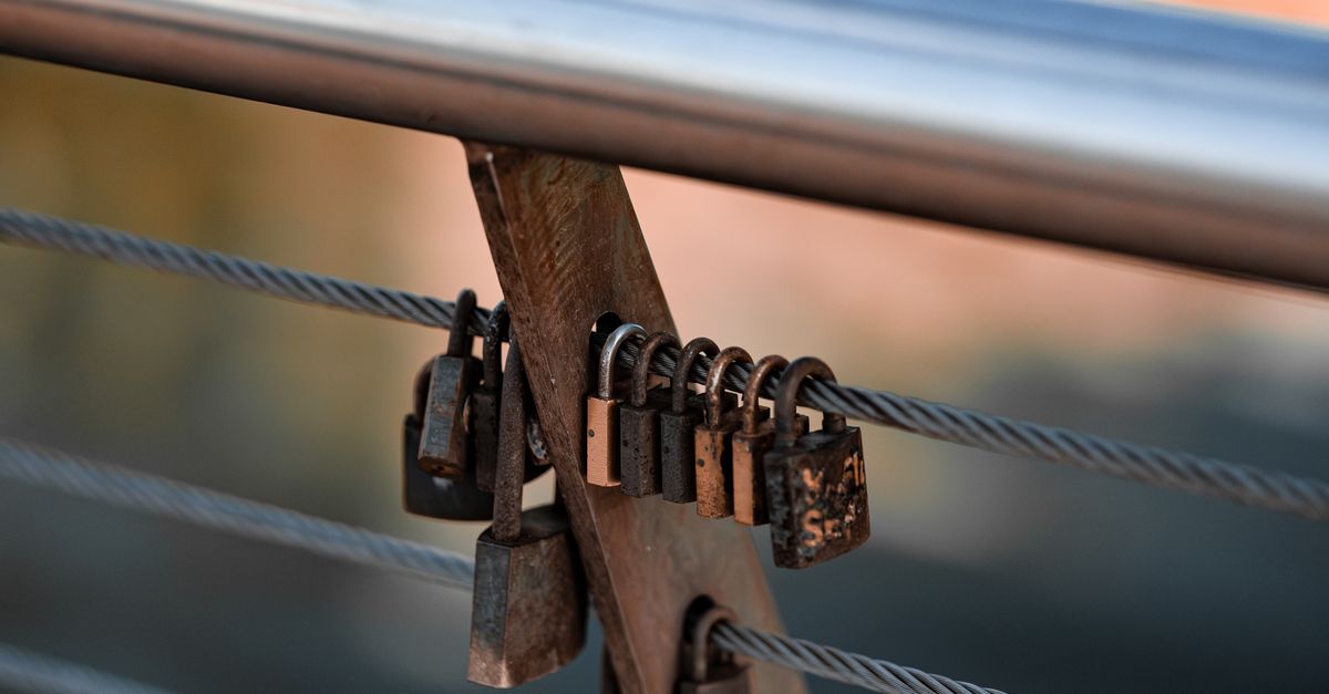 Lock Block For Railing A metal railing with a lock on it · Free Stock Photo