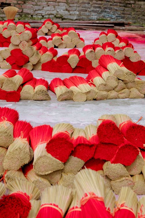 Free Bundles of red incense sticks drying under natural light outdoors. Stock Photo