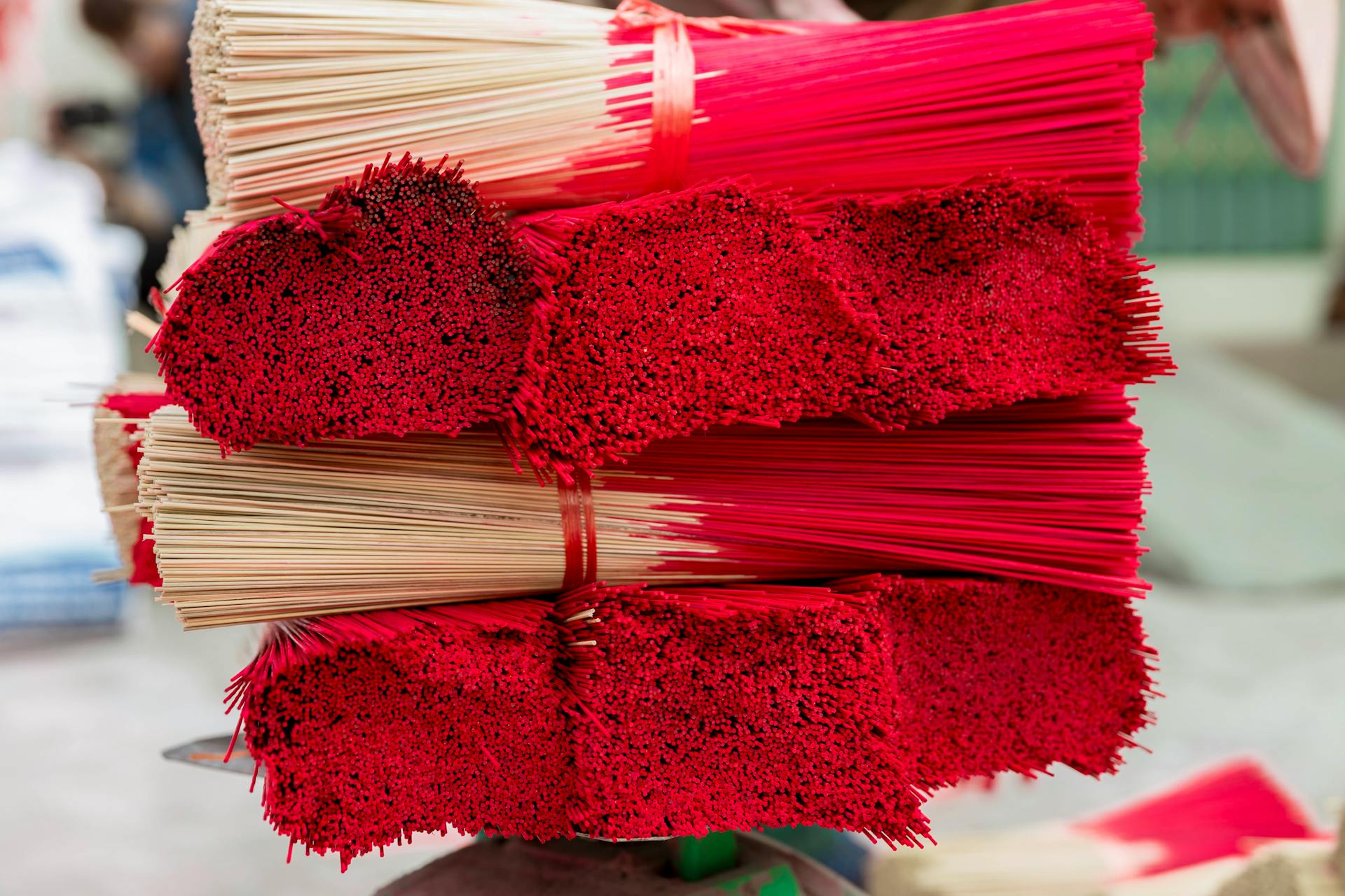 A stack of red sticks with red and white paper
