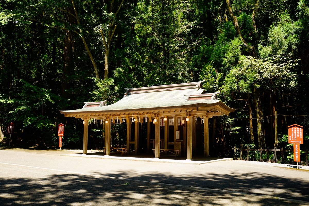 A wooden Shinto shrine set in a tranquil mountain forest, evoking Mitsumine Shrine high above Chichibu