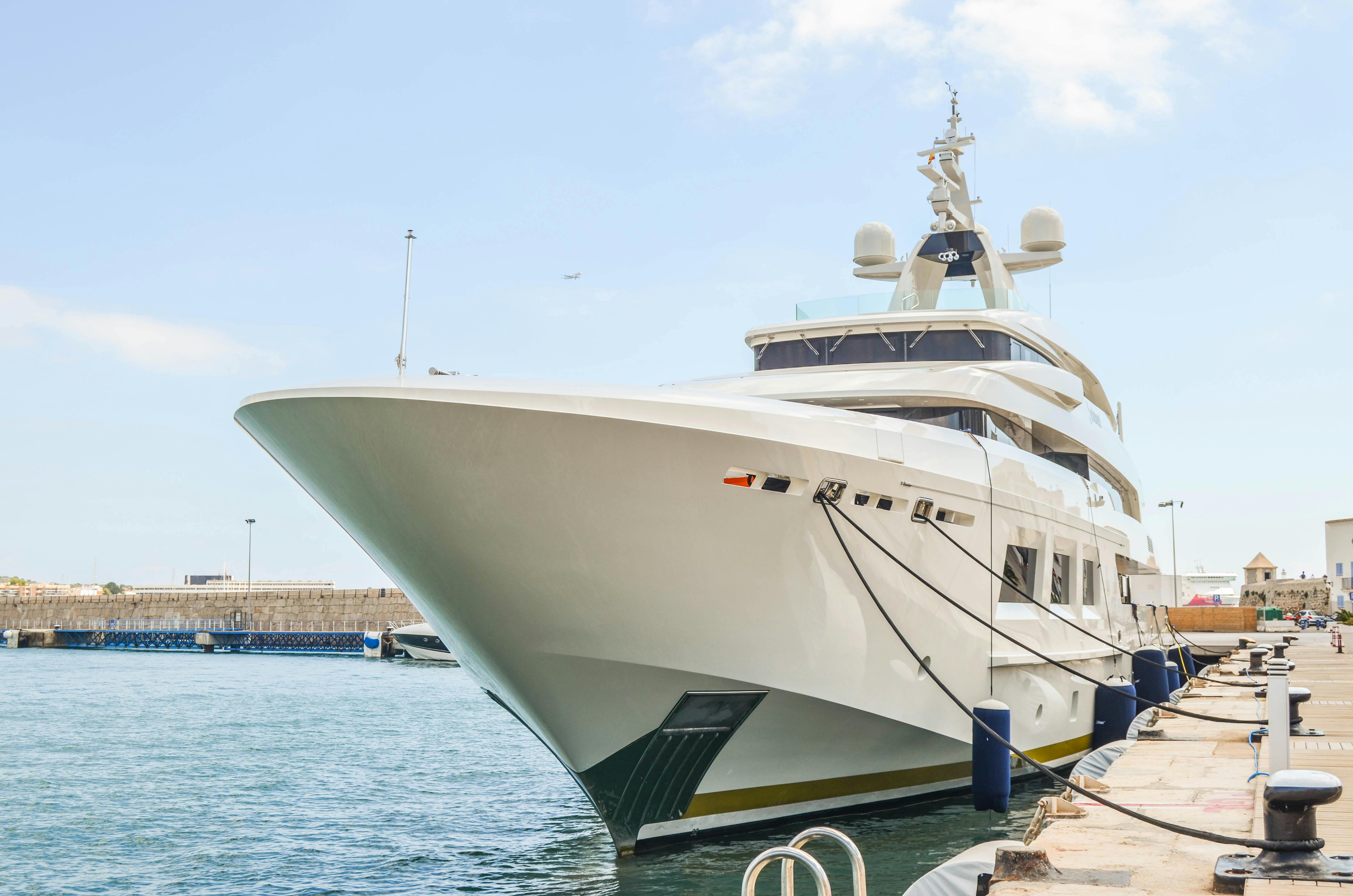 a large white yacht docked at a dock