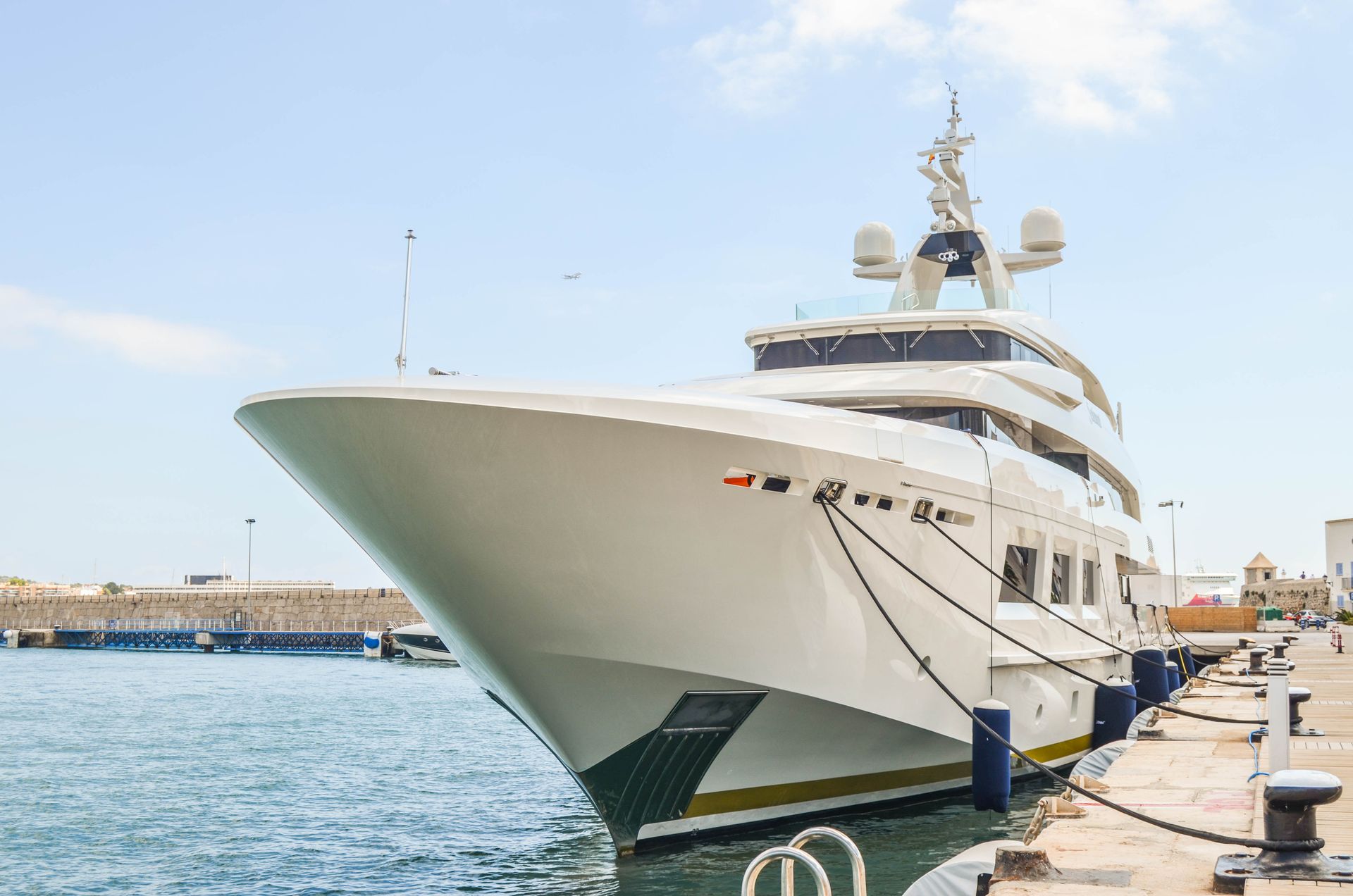 A large white yacht docked at a dock