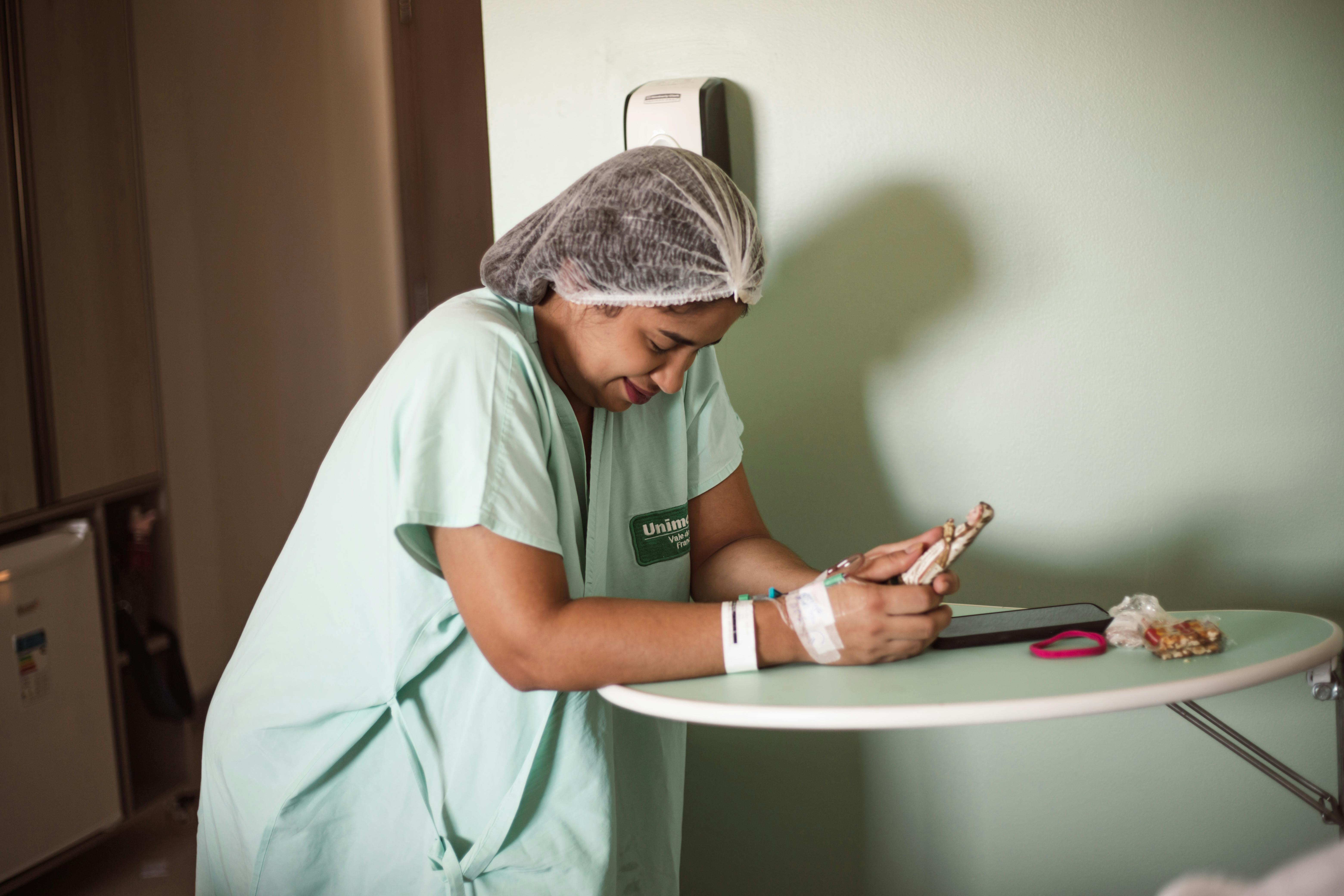 a nurse in scrubs using a tablet