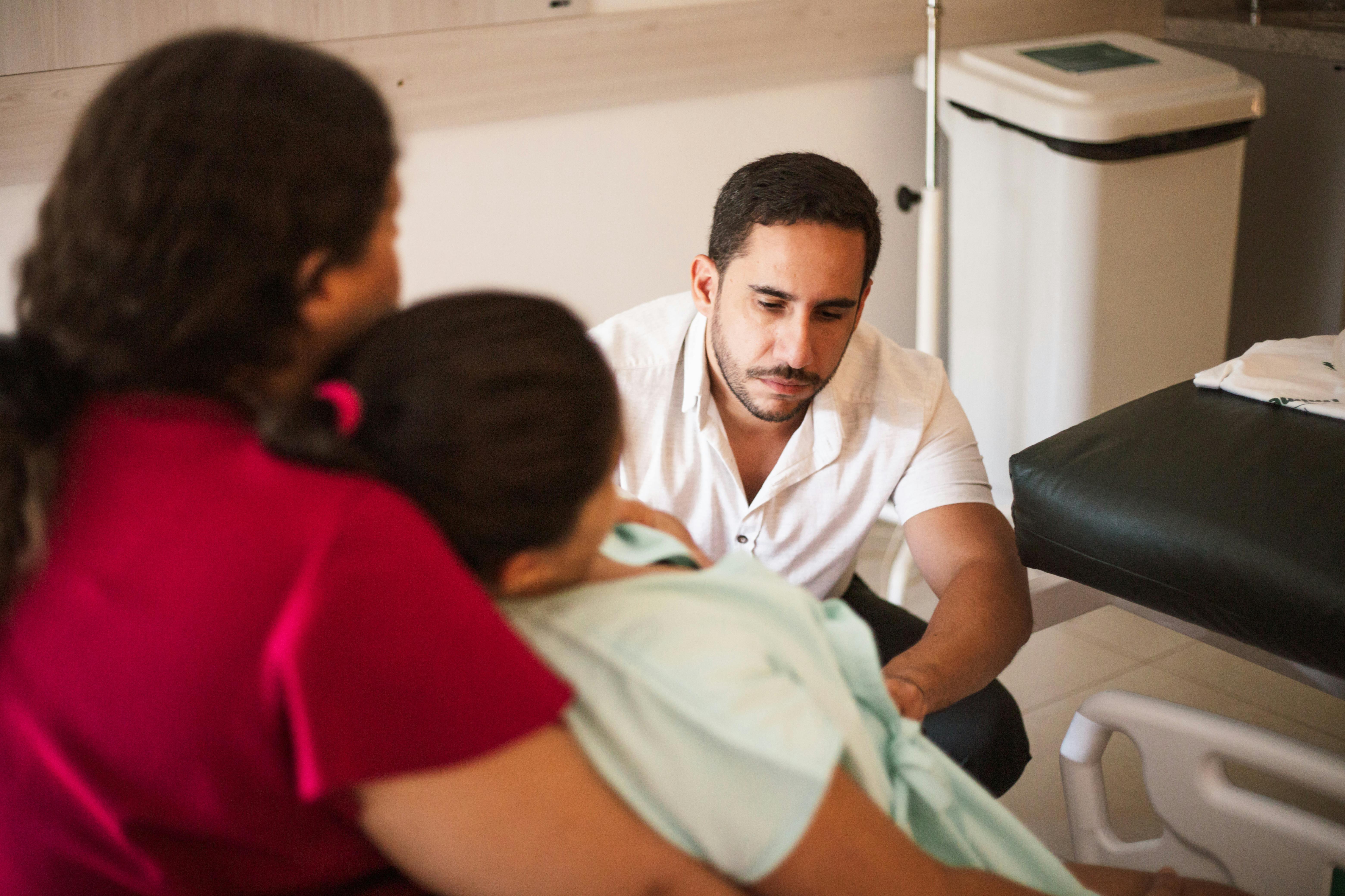 a man and woman are talking to a baby