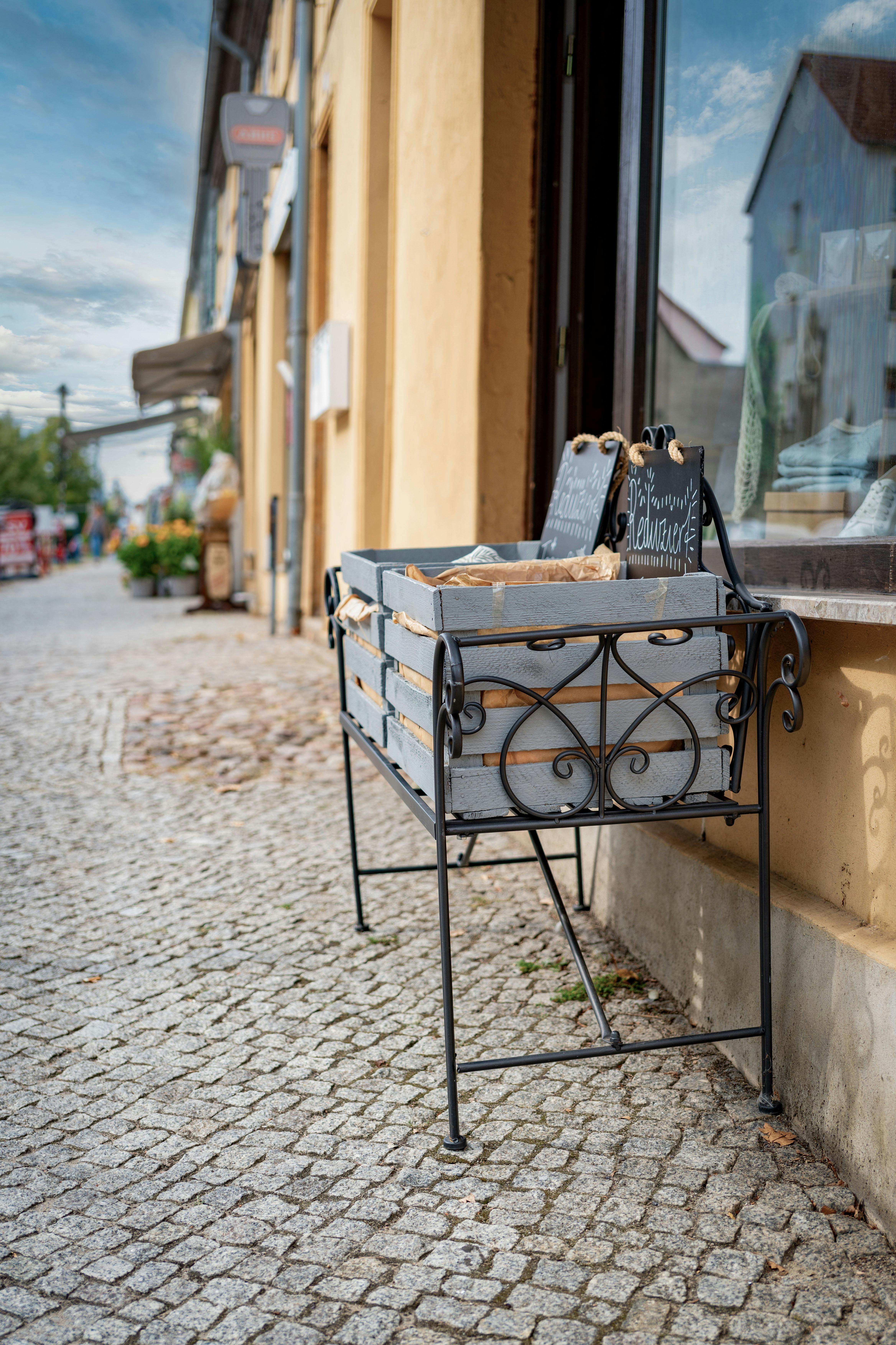 Rustic bread display on a charming cobblestone street market setting.