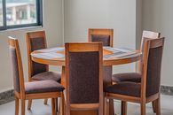 A stylish wooden dining table with chairs in a modern room in Ecuador.
