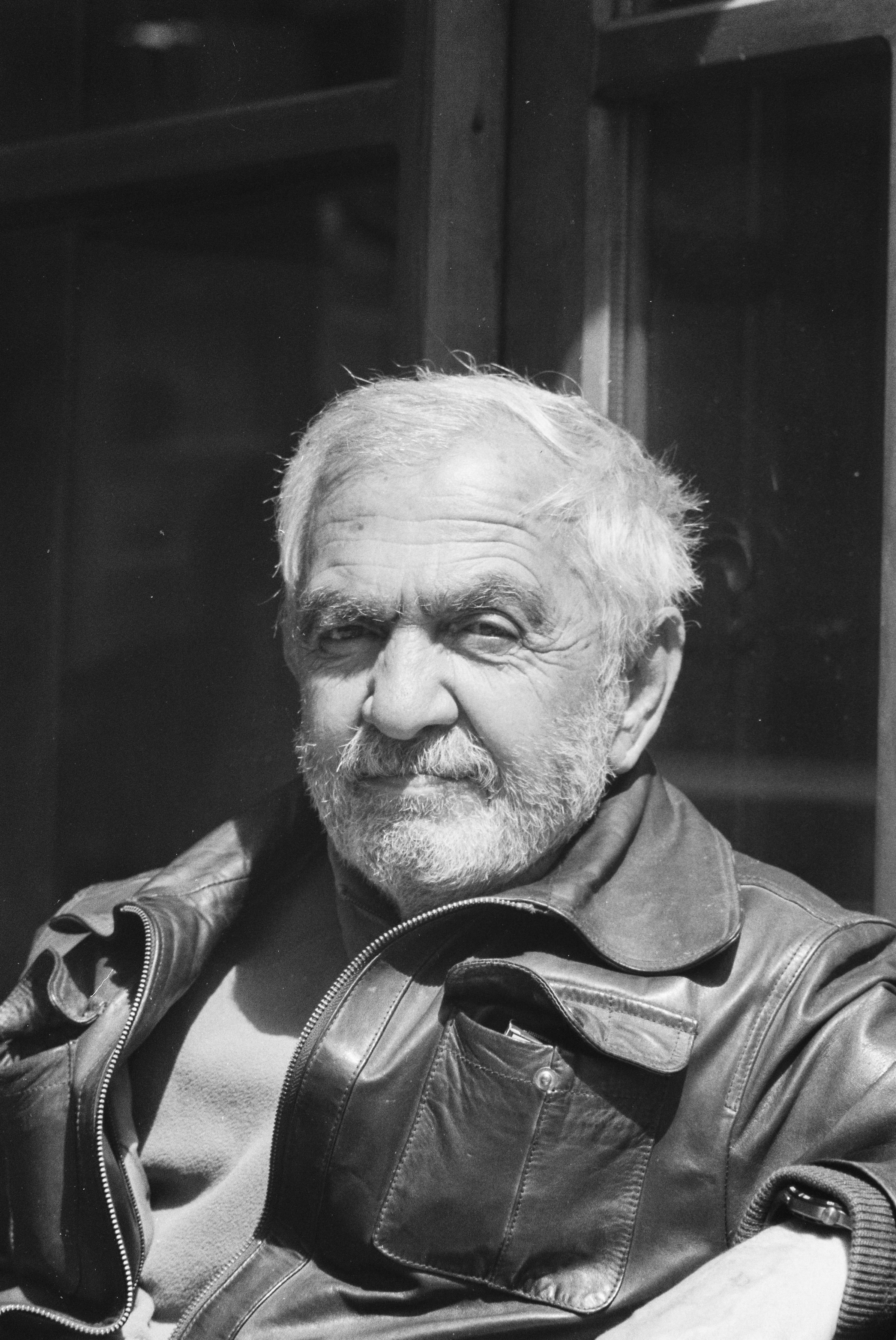 Black and white portrait of elderly man wearing a leather jacket in Safranbolu, Türkiye.