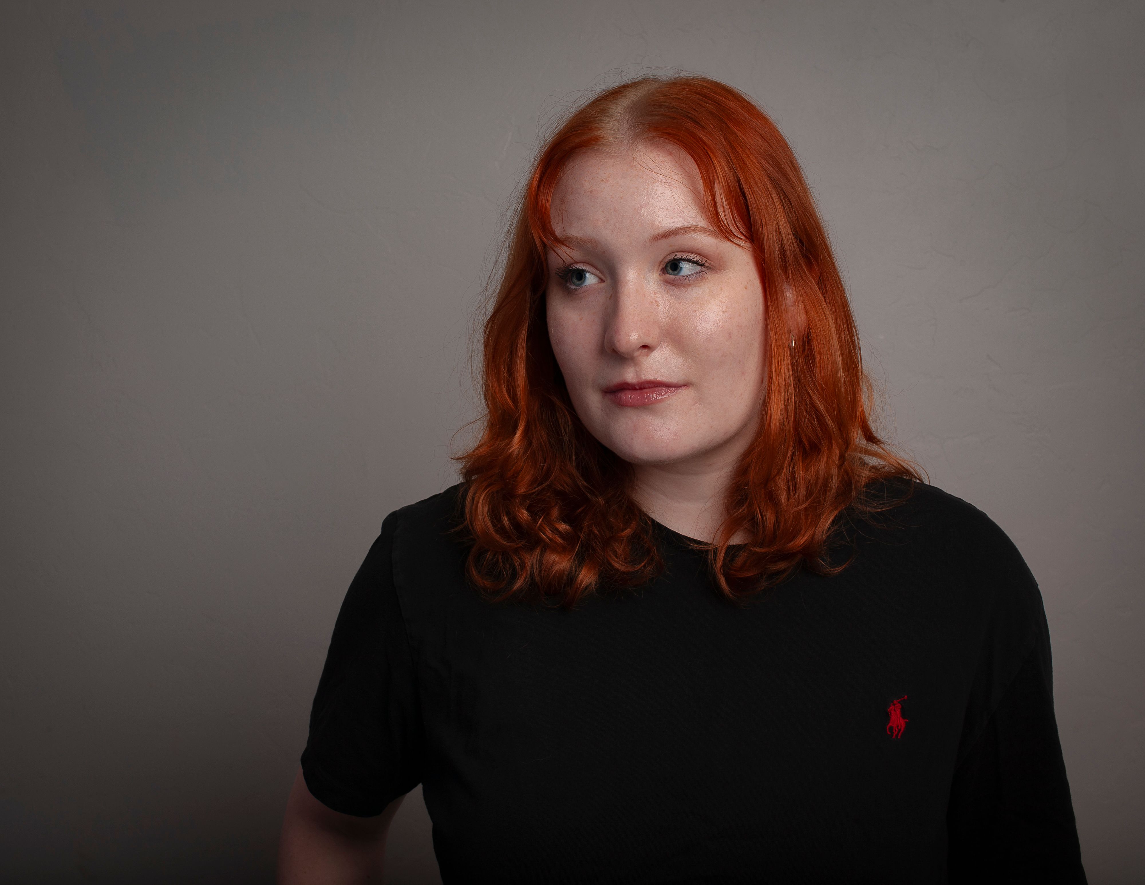 A woman with red hair and a black shirt · Free Stock Photo