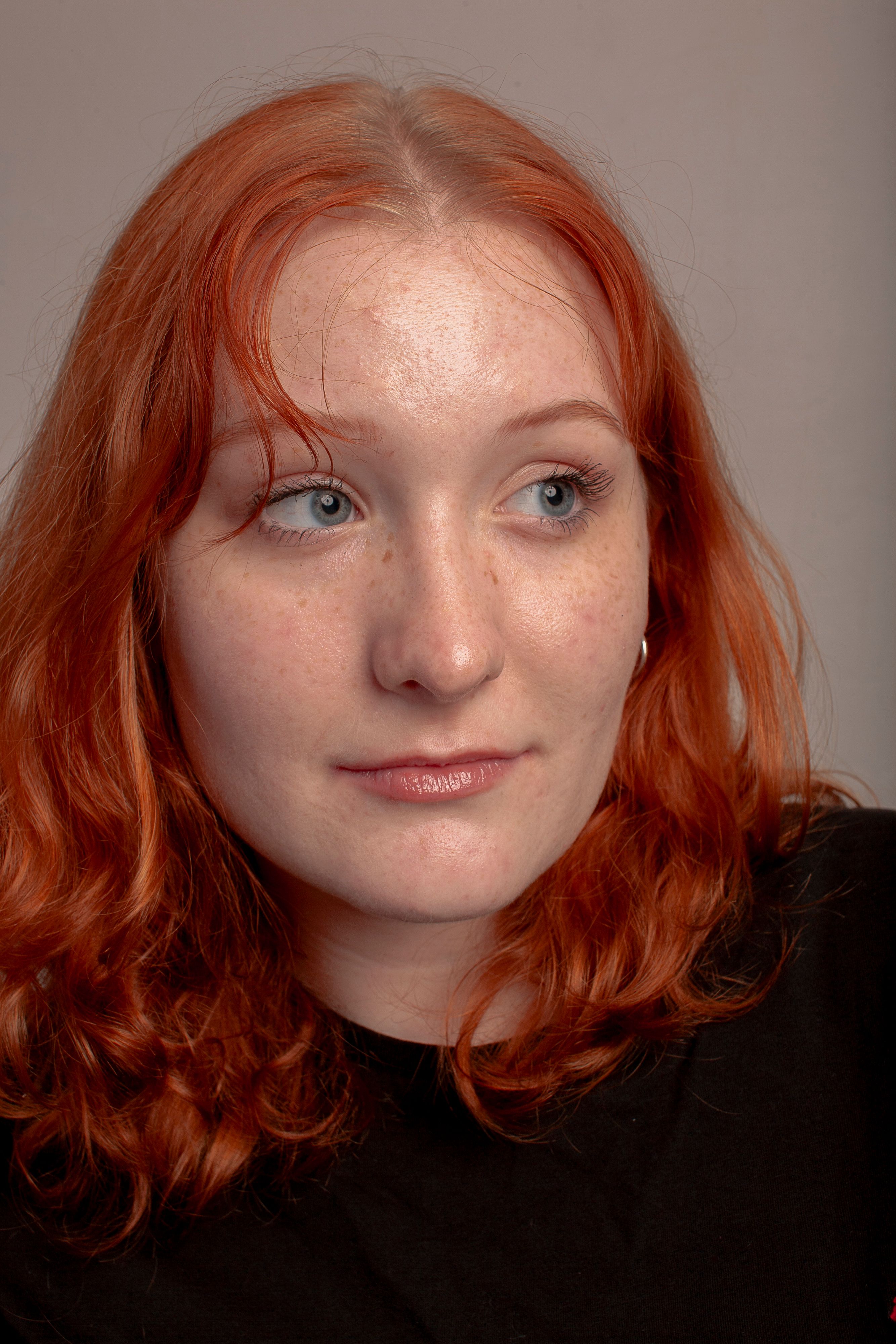 A woman with red hair and a black shirt · Free Stock Photo